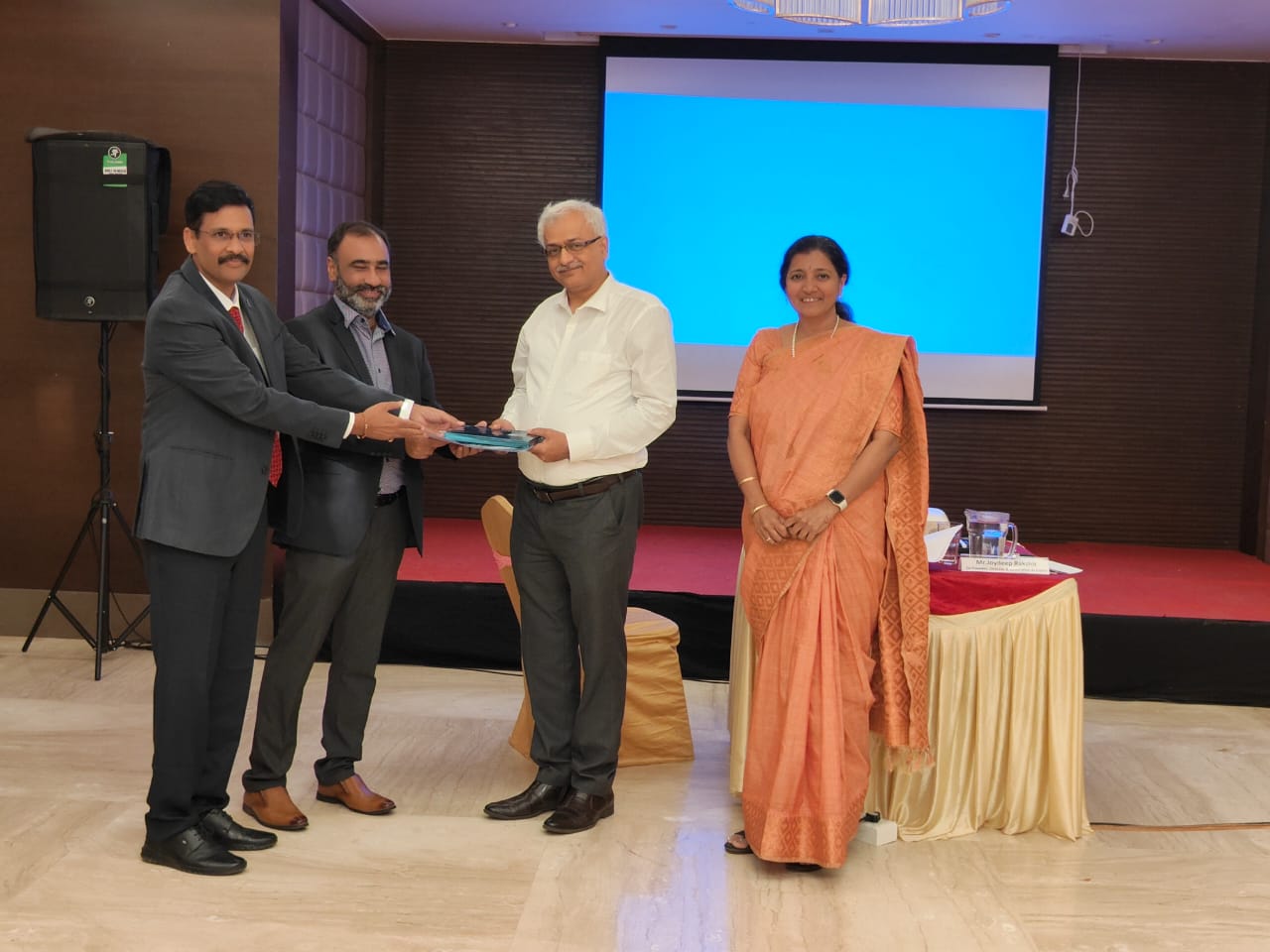 Recognition being presented on stage after a session