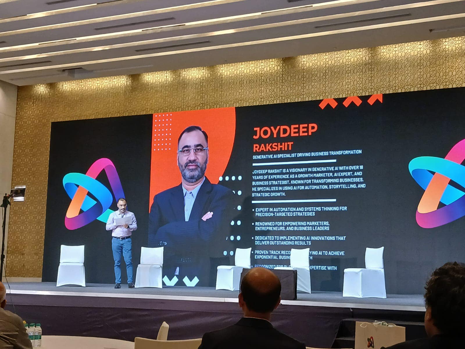 Joydeep Rakshit introduced on the main stage of a generative AI conference